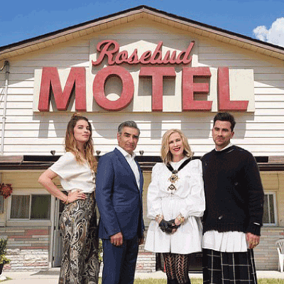 Main Characters from Schitt's Creek standing in front of the Motel