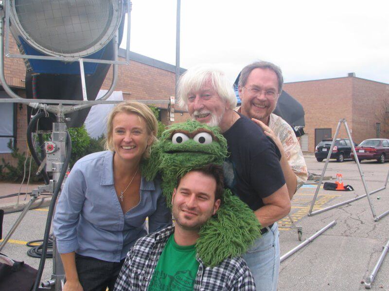 Jo-Anne St. Godard, Executive Director with Grouchy character from Sesame Street